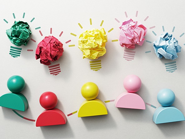 colourful figures with colourful bits of paper rolled into balls symbolising creative ideas and teamwork